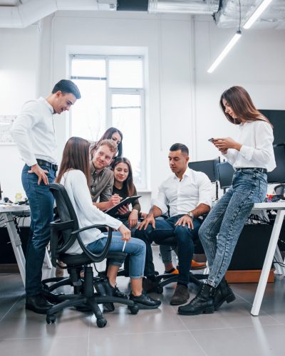 Group of young business people that standing and sitting and working in the office.