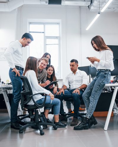 Group of young business people that standing and sitting and working in the office Group of young business people that standing and sitting and working in the office.