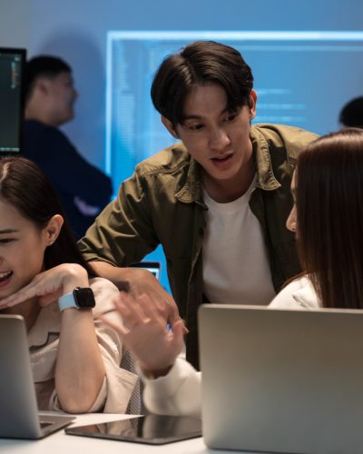 Young Asian business people working late into the night in the office, meeting, brainstorming, presentation working about coding